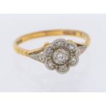 A diamond and 18ct gold cluster ring, flower cluster grain set with small diamonds, width approx