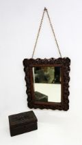 A Chinese early 20th Century carved hardwood mirror along with an Indian carved hardwood trinket