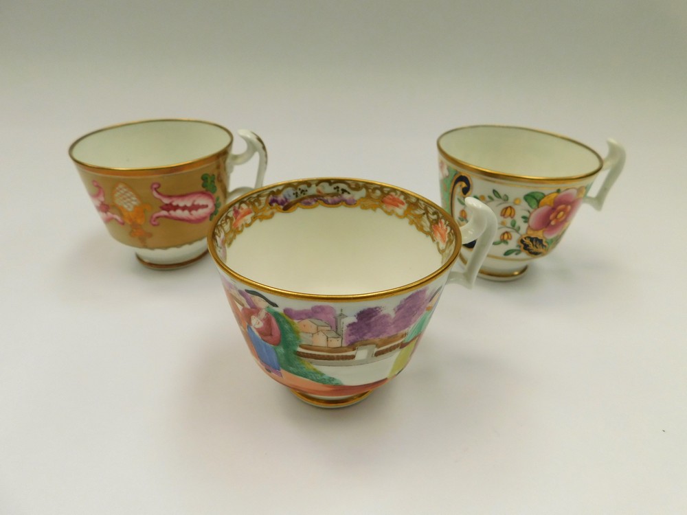 Three Swansea tea cups, Mandarin and French Tulip patterns, one marked Swansea in red script.