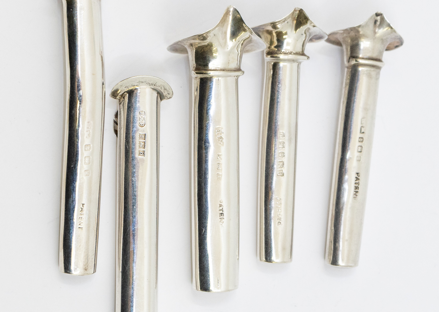 Boutonnieres: a collection of five 20th century silver buttonhole posy holders, all with floral - Image 2 of 2