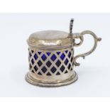 A Victorian Irish silver drum mustard pot, pierced diamond lattice style casing, scrolled handle and