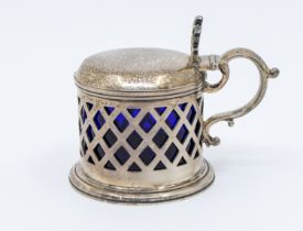 A Victorian Irish silver drum mustard pot, pierced diamond lattice style casing, scrolled handle and