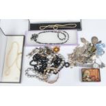 A collection of costume jewellery comprising various silver jewellery including chains, stick pin,