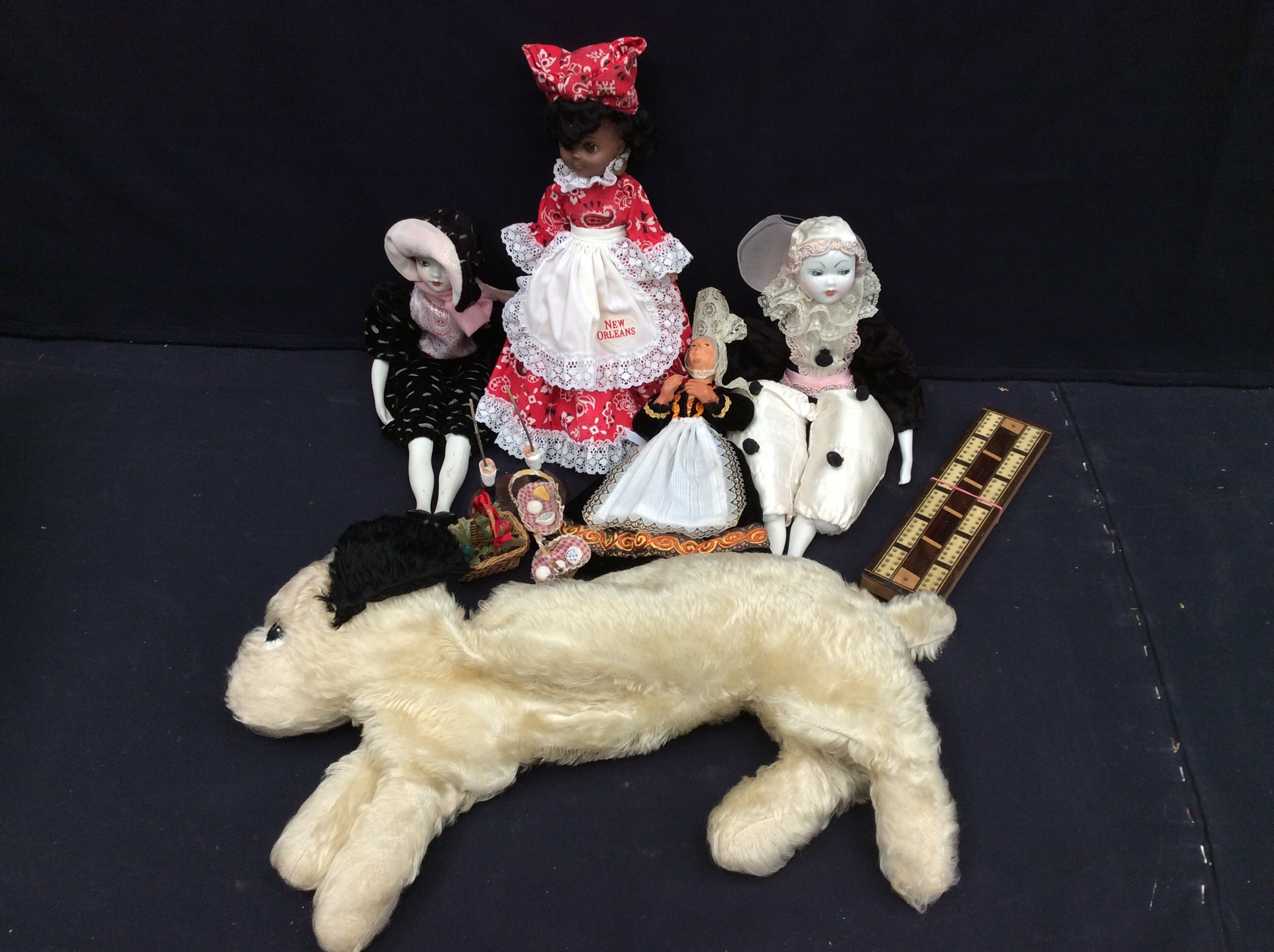 A mixed collection of 20th century or modern dolls and others, also a dog cuddly toy pyjama case. (1