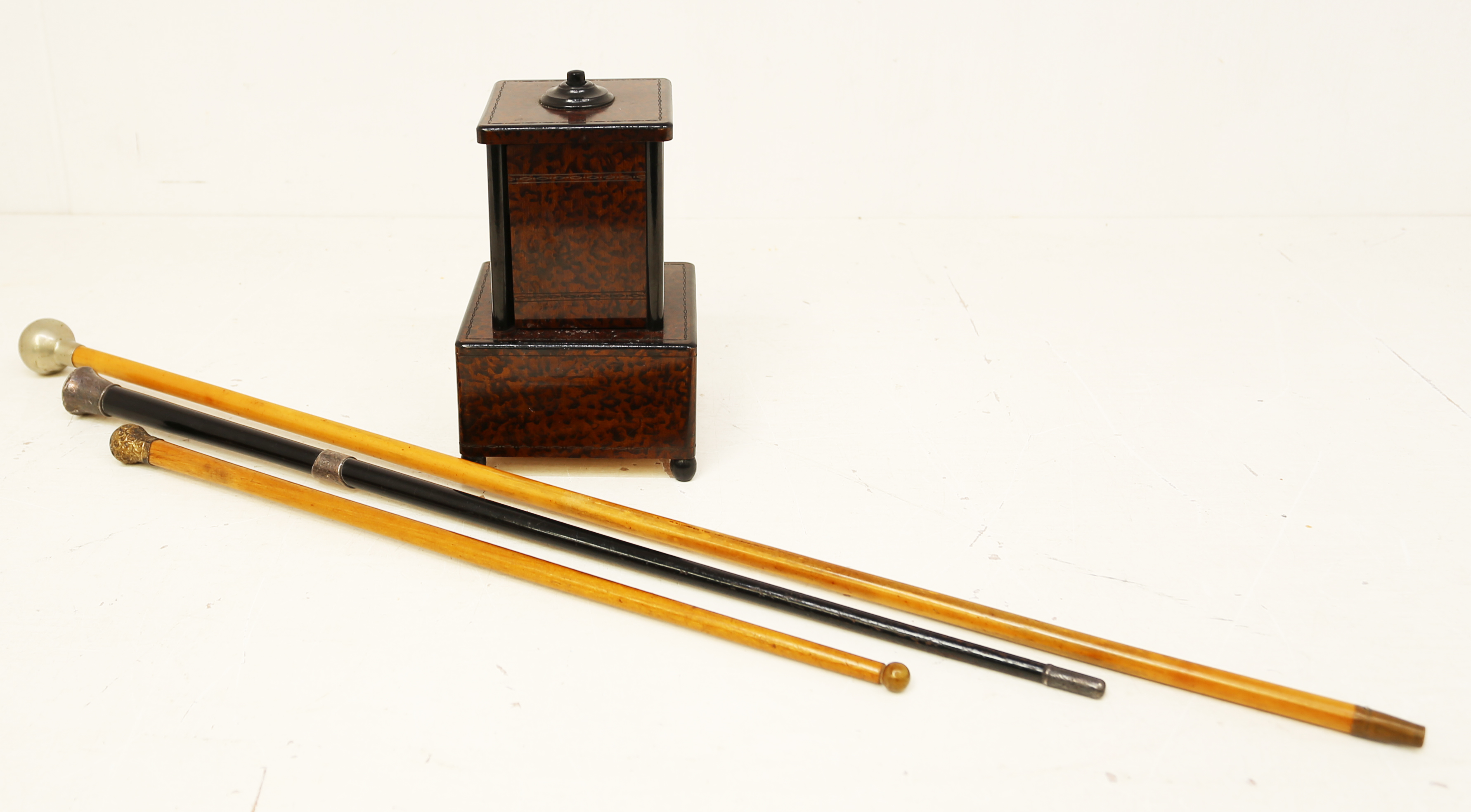 Two early 20th Century conductors sticks, police sticks and a Bakelite cigarette box.