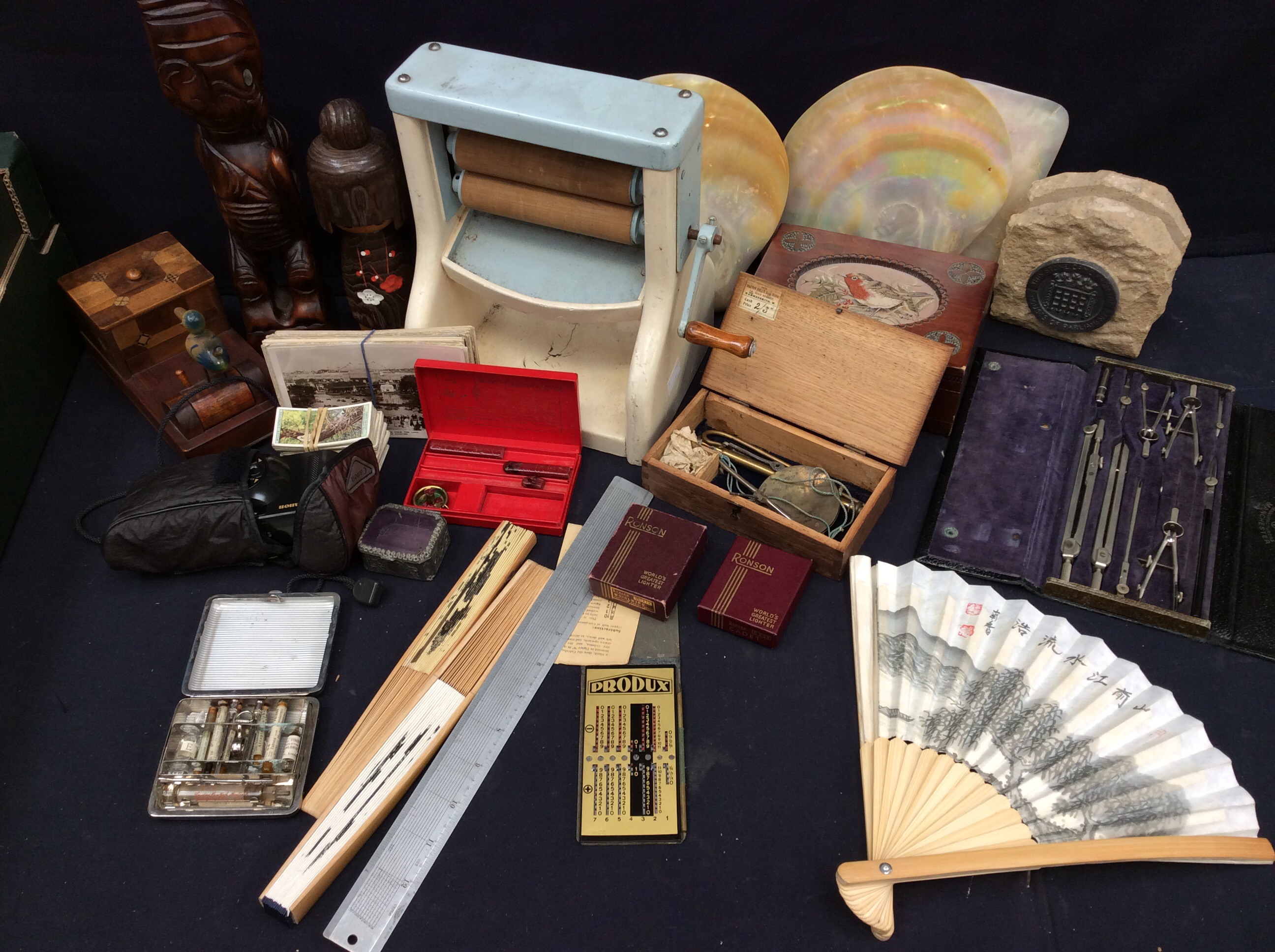 A mixed collection of collector's items to include treen boxes, wooden figures, cigarette box,