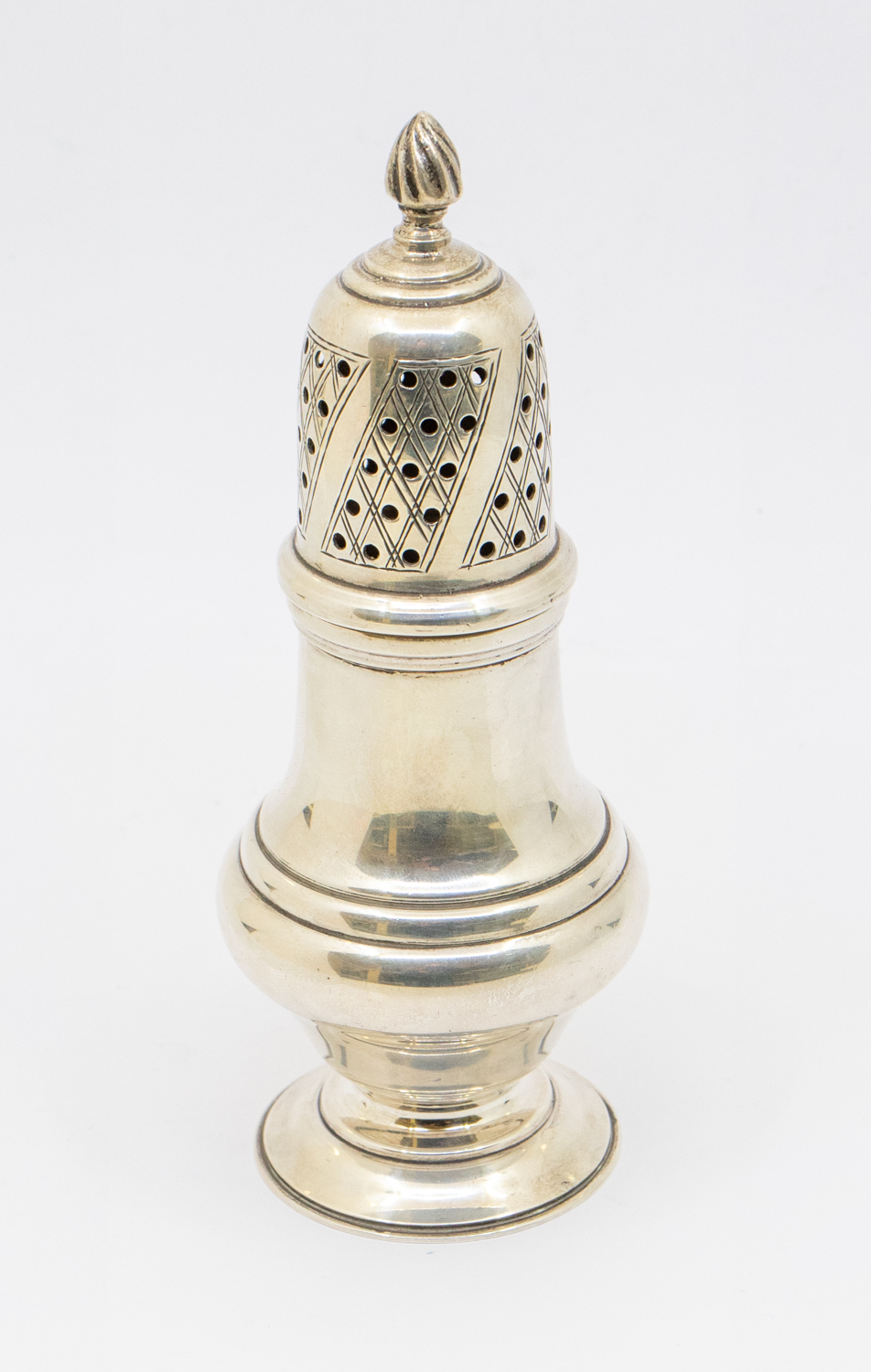 An Elizabeth II silver sugar caster, circular footed base with detachable top with swirled finial,