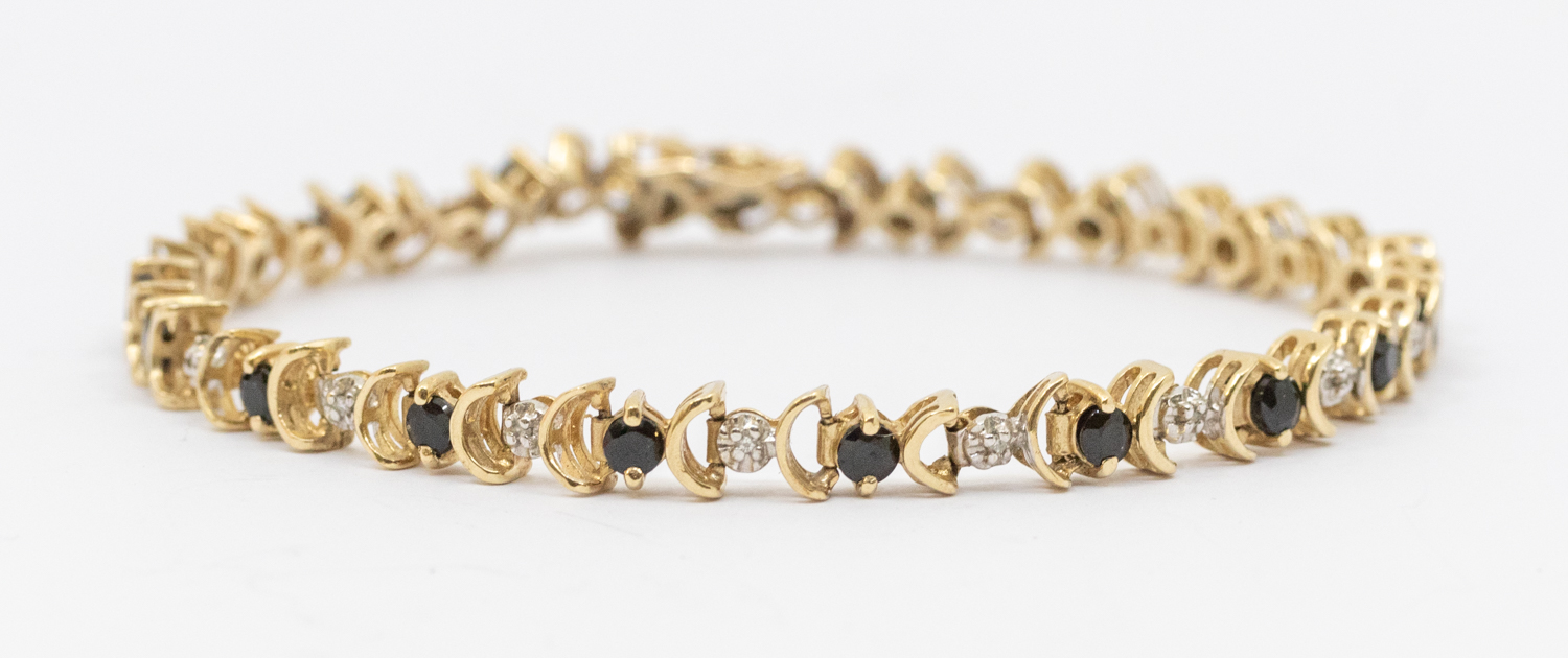 A sapphire and diamond gold bracelet, comprising alternate grain set diamond links and single