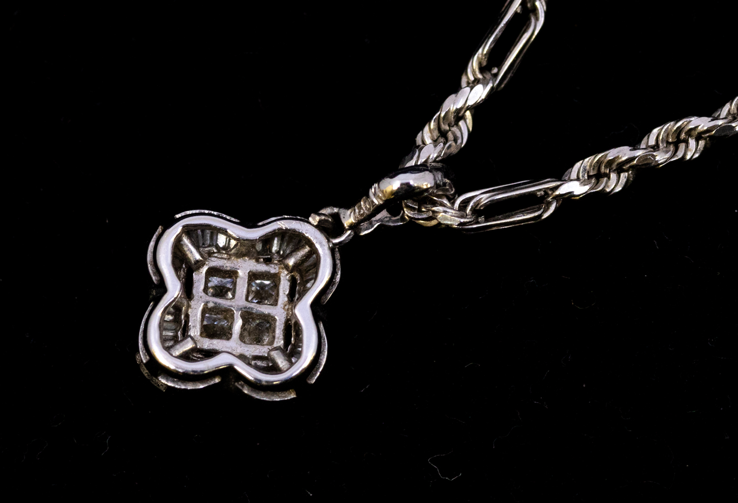 A diamond and 18ct white gold pendant, comprising a quatrefoil design set to the centre with four - Image 2 of 2