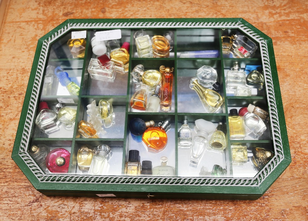 A collection of forty-three miniature and sample perfume bottles, comprising vintage and later