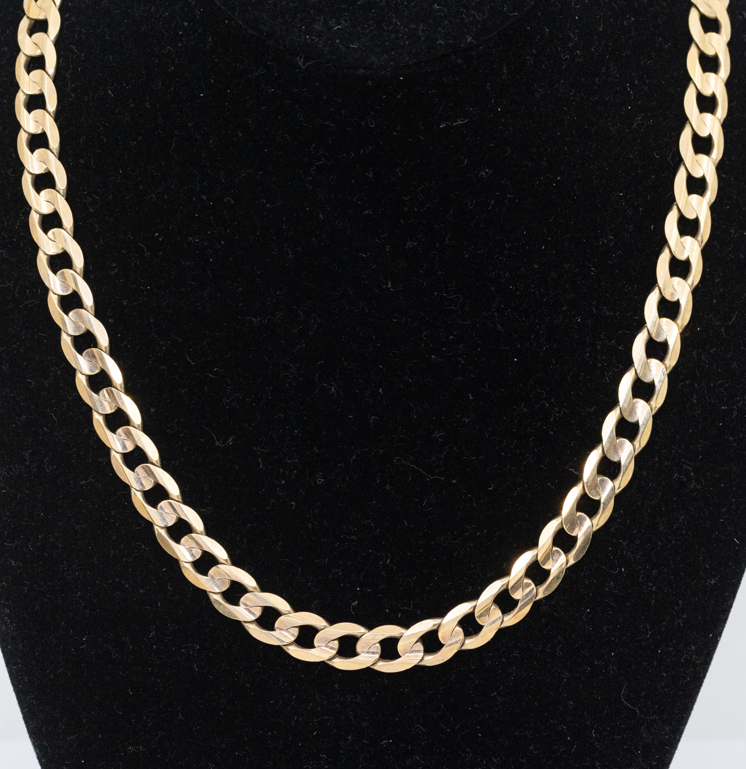 A 9ct gold curb link chain, width approx 7mm, length approx 51cm, weight approx 31.4gms  Further