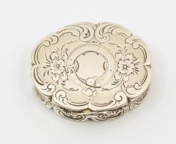 A Victorian silver shaped oval vinaigrette, scalloped border, engraved with flowers and foliage, the