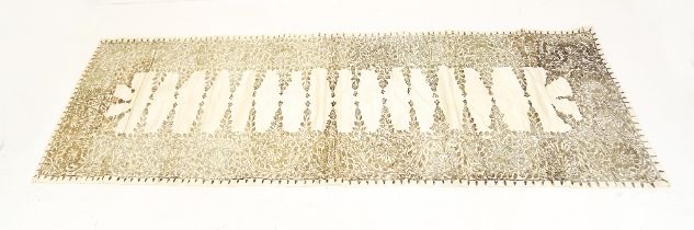 An Indian table runner with silver braiding sequins stitched onto silver and gold intricate thread