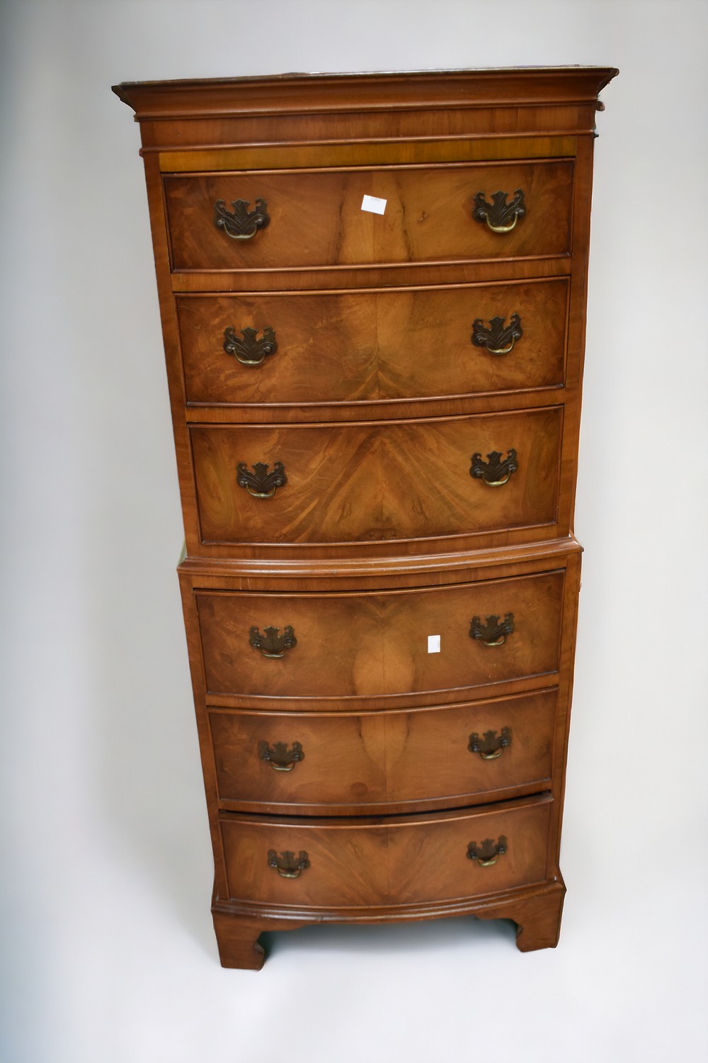 A reproduction mahogany chest on chest along with a matching dropleaf sewing table.