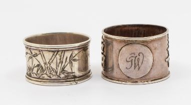 A Chinese silver napkin ring, with relief Chinese script to sides and initialled circular cartouche,