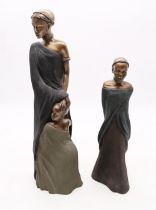 Two bronzed African figures of ladies with child