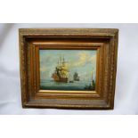 A 20th Century print on canvas in reproduction gilt frame of Galleons on sea.