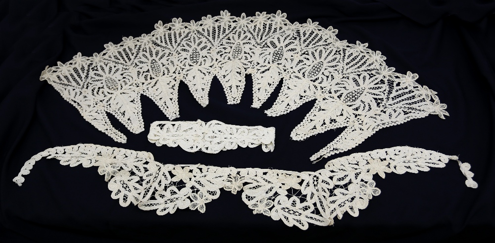 A cotton lace collection of collars, belts and peplums of floral design.