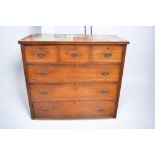 A large Edwardian mahogany chest of three drawers above three drawers, with brass swing handles, sat
