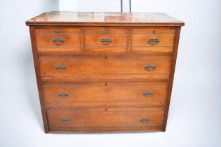 A large Edwardian mahogany chest of three drawers above three drawers, with brass swing handles, sat