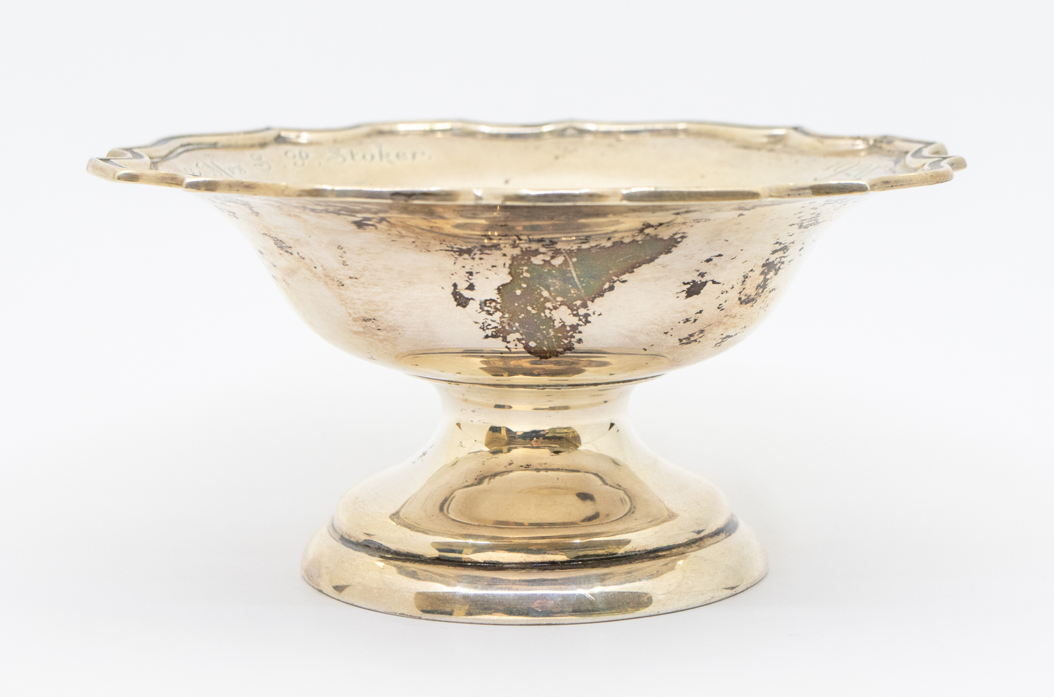 A George V silver bonbon dish, curved edge, on circular footed base, engraved "1928 - ALAN -