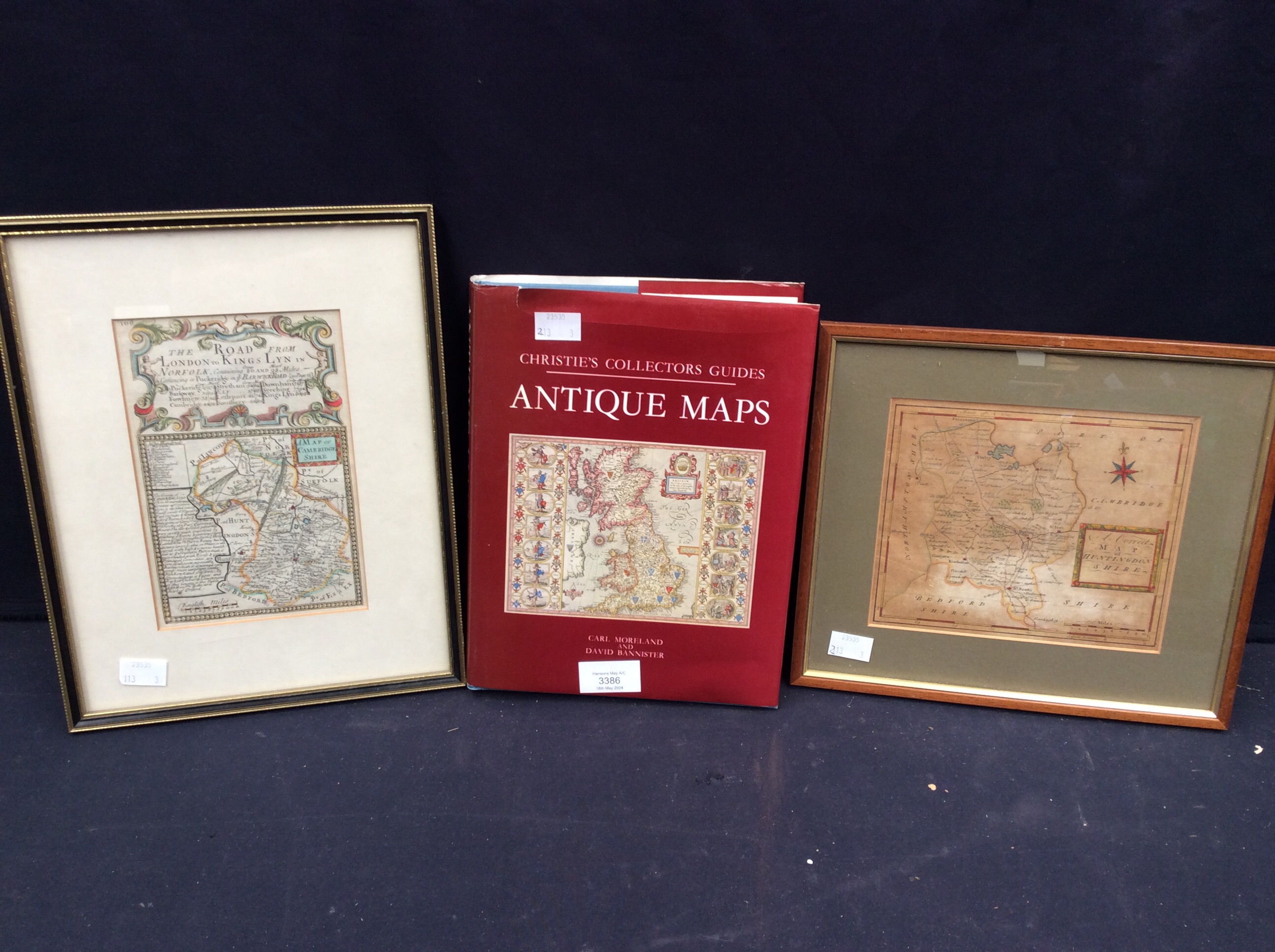 An 18th Century framed map of road from Kings Lynn to London with a framed map of Huntingdon and a