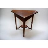 A 19th Century mahogany drop front corner table/stand on inlayed sabre legs.