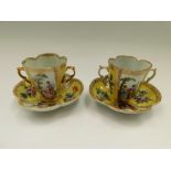 Two Dresden quatrefoil twin-handled chocolate cups and saucers, with two yellow ground panels