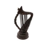 A hand-carved bog oak miniature harp, 18.5cm tall