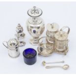 A collection of various silver condiments to include:  1. A Victorian large urn shaped pepper pot,