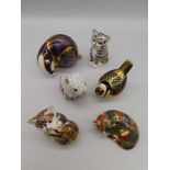 A collection of six Royal Crown Derby paperweights, including 5 gold stoppers and 1 silver stopper.