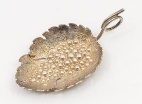A George III silver caddy spoon, of leaf shape with grape and vine decoration, spiral vine handle,