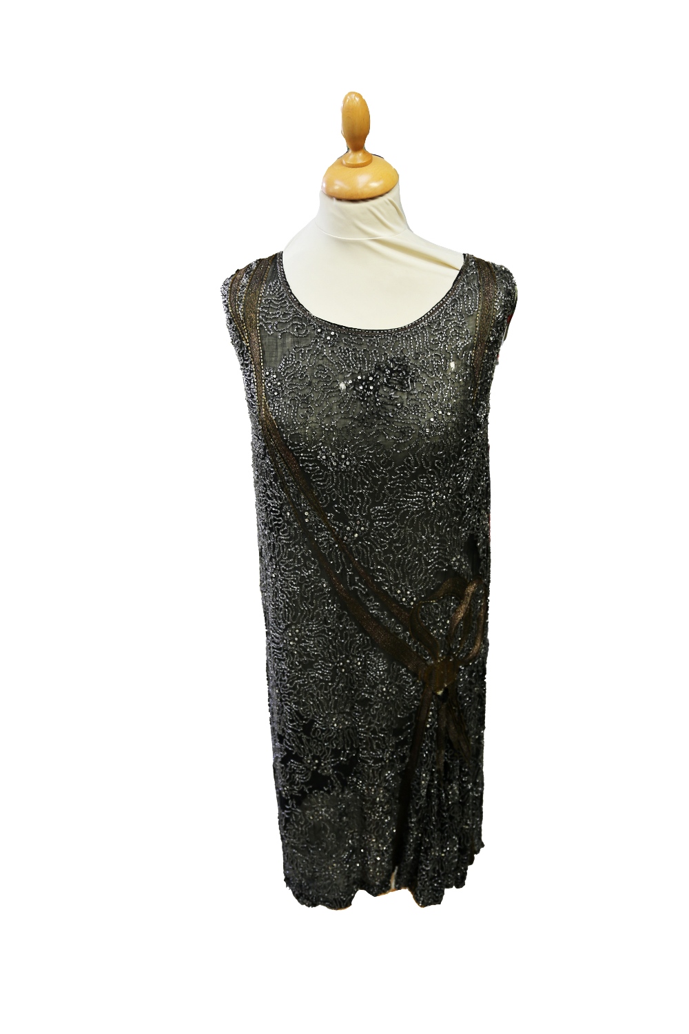 A black beaded mid 1920s dree with grey beads and paste stones, a decorate braided 'Deco' runs