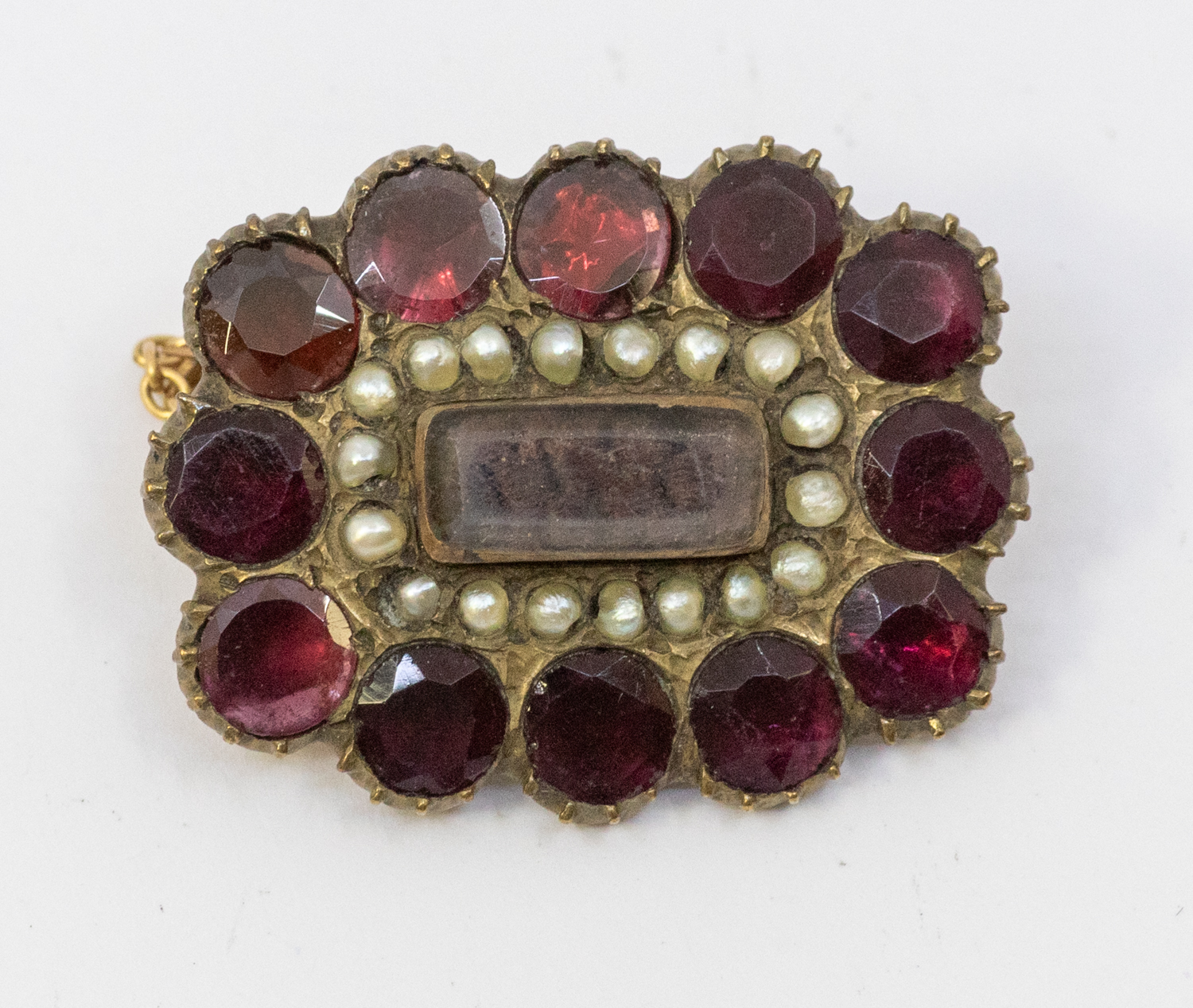 A Georgian flat cut paste and seed pearl gilt mourning brooch, comprising a central glazed hair - Image 2 of 2