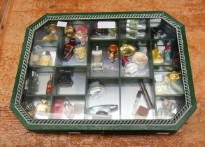 A collection of thirty-four miniature and sample perfume bottles, comprising vintage and later