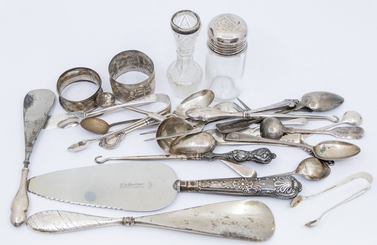 A mixed collection of silver flatware to include; a George V silver bread fork, hallmarked by C.T.