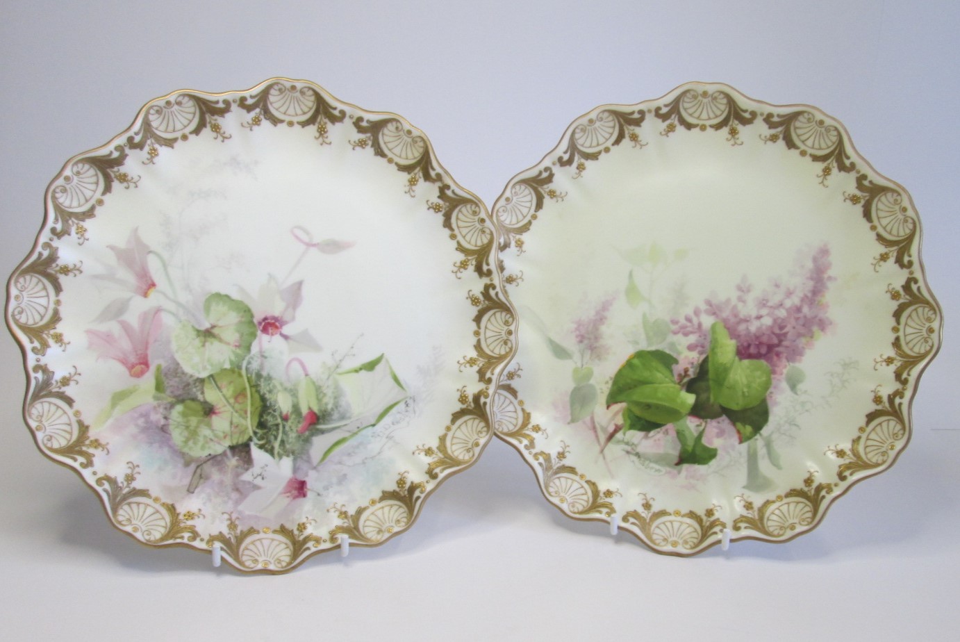 A pair of Royal Doulton, Burslem,  Rd No 72067 gold gilt scalloped plates hand painted and signed by