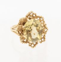 A vintage citrine and 9ct gold dress ring, set with an oval mixed cut citrine within a textured