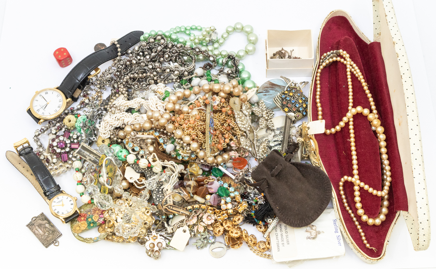 A collection of vintage costume jewellery to include silver charms, faux pearls and beaded necklace,