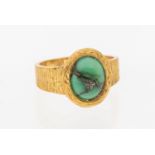 A turquoise 18ct gold ring, comprising an oval turquoise set to a bark textured band,width approx
