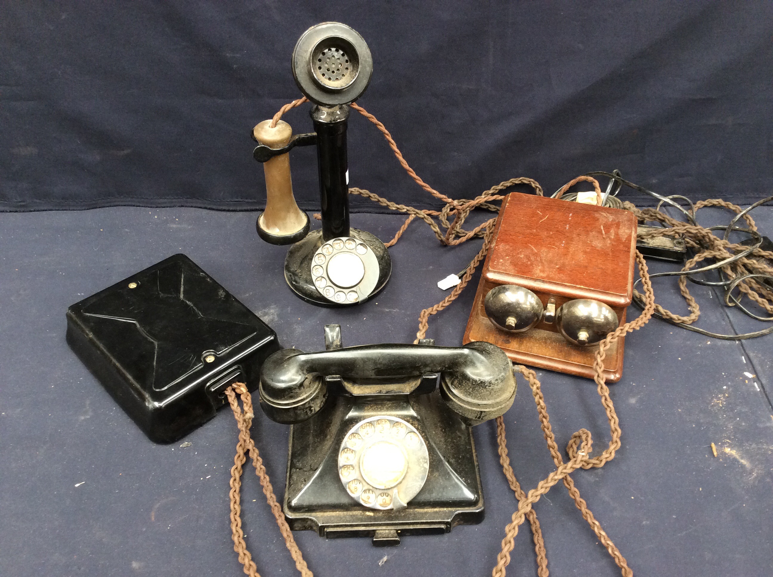 A collection of vintage early 20th Century telephones, wall and table top.