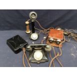 A collection of vintage early 20th Century telephones, wall and table top.