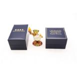 A Halcyon Days unboxed enamel of a teddy bear with Olympic flame, another boxed wearing cap and
