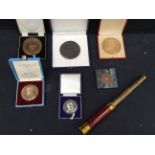 A collection of cased bronze medallions/awards for service in poultry along with a small telescope.