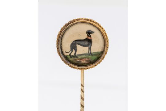 An Essex crystal gold stick pin, comprising a round crystal depicting a Greyhound, within a beaded - Image 1 of 2