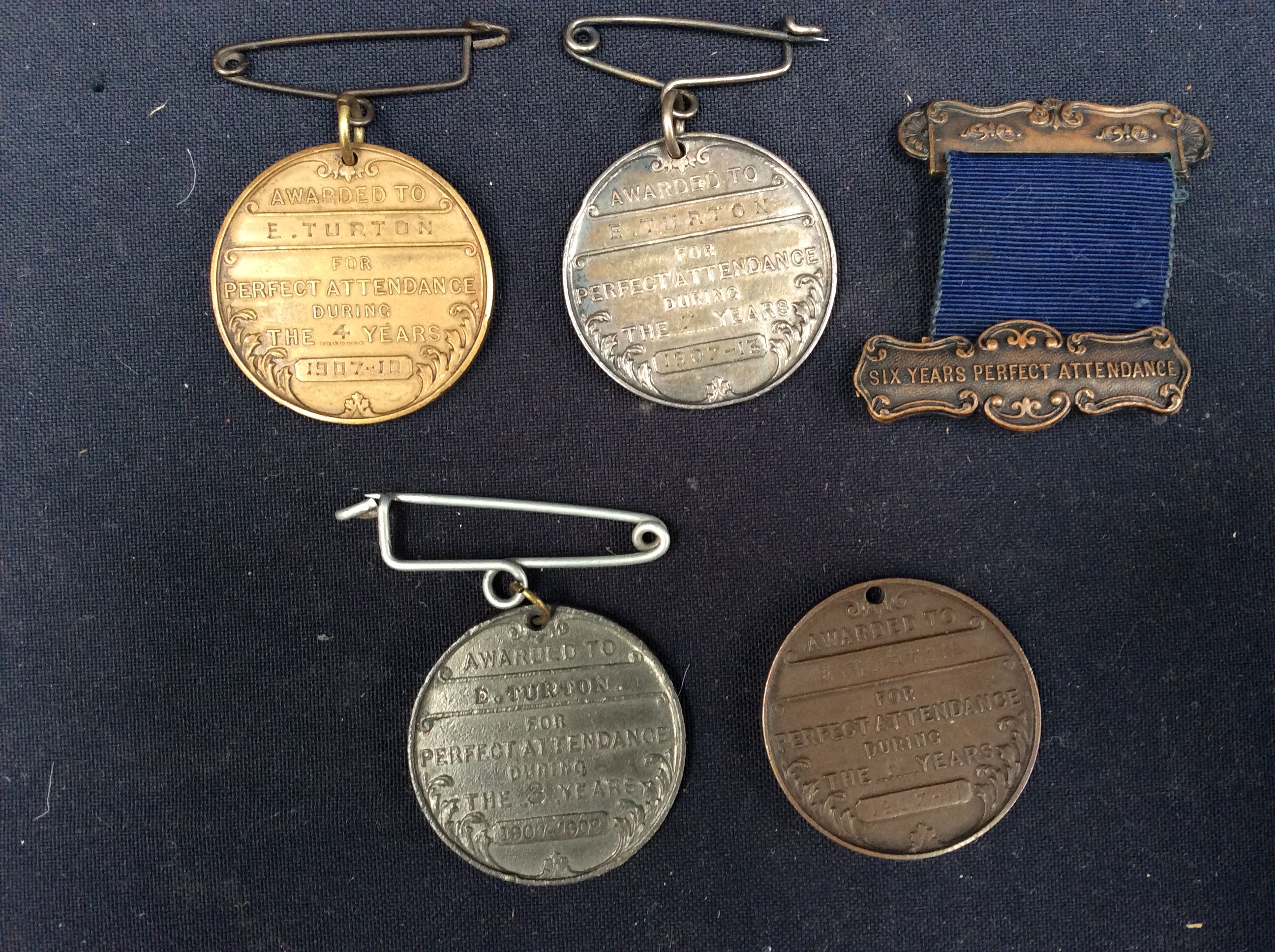 A small collection of four metal West Bromwich Education Committee medals, all awarded to E.