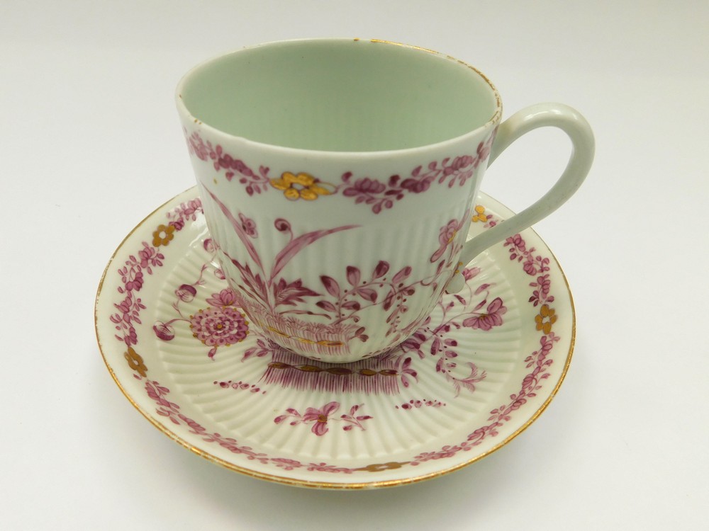 An English porcelain late 18th century fluted  tall tea cup and saucer, decorated in puce and gilt
