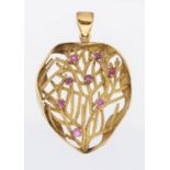 A ruby set stylized gold pendant, comprising an irregular shaped frame, inset with gold barely