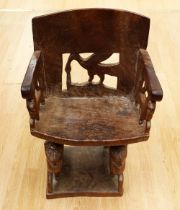 A late 19th Century/early 20th Century solid hard wood African tribal seat/chair with bird and