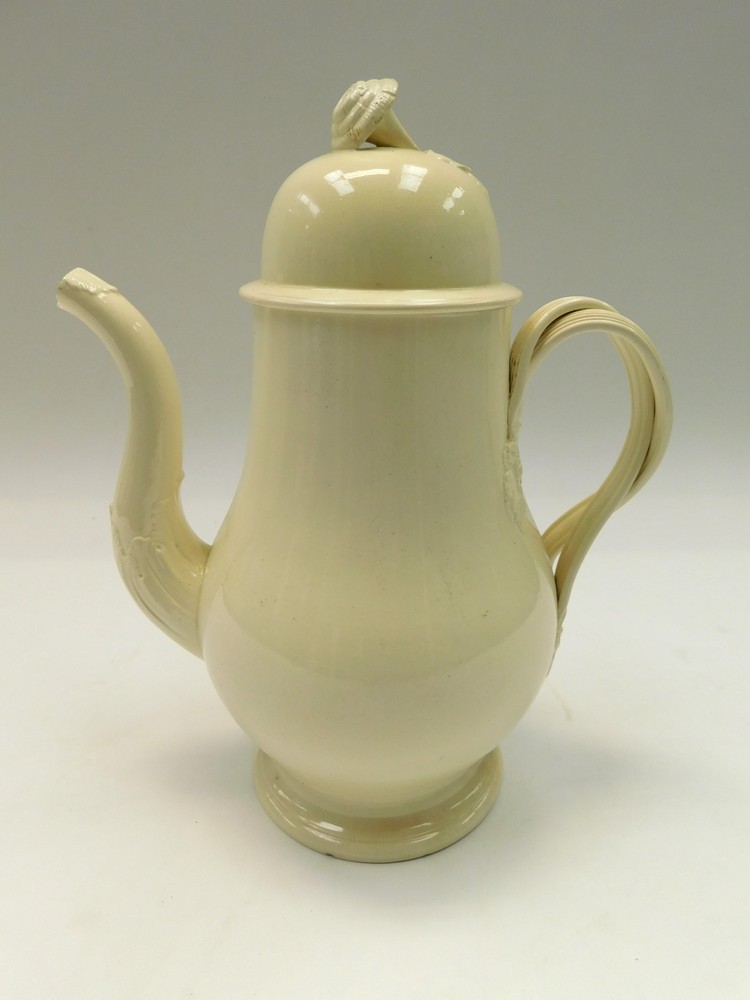 An 18th Century Creamware large pear shaped coffee pot and domed cover, plain body with intwined